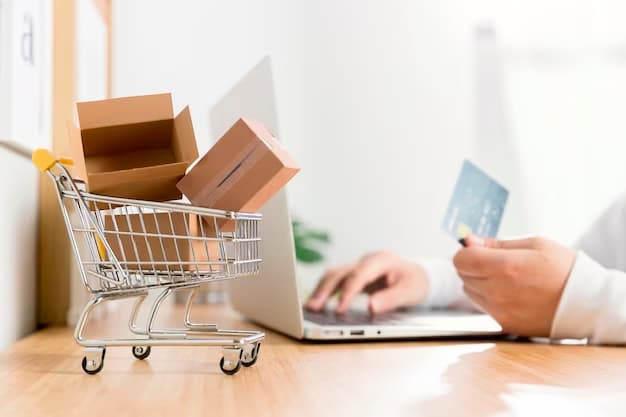 Person at laptop with credit card and mini shopping cart